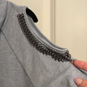 Full zip hooded sweatshirt with metal cold shoulder details.